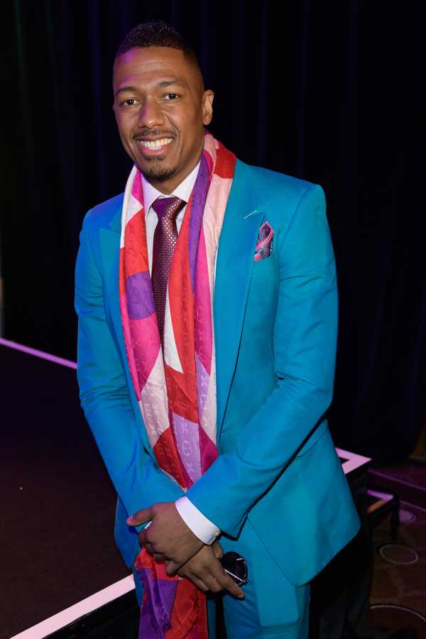 尼克·坎农(Nick Cannon)穿着西装和领带对着镜头微笑